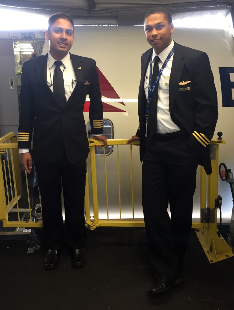 Two Vaugn Alumni Pilots smiling while at work